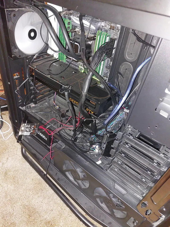 Inside an open PC case: motherboard, RAM, an NVIDIA RTX 4060 Ti graphics card and liquid cooling tubes